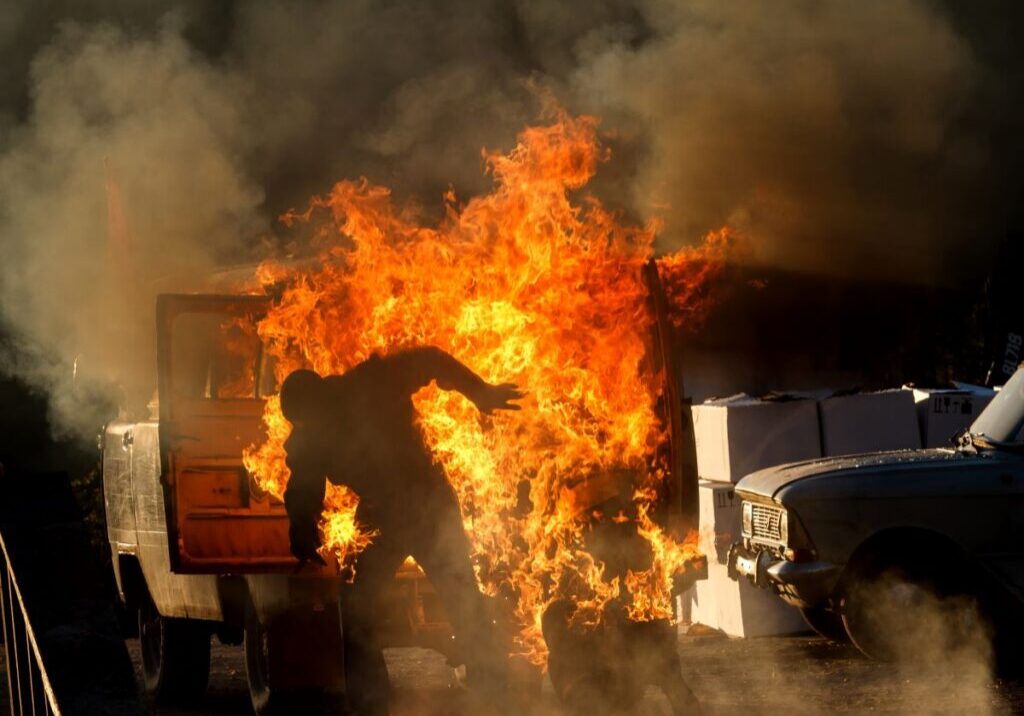 Burn Use Man moving away from a large fire