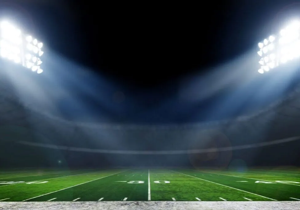 Football field illuminated by stadium lights
