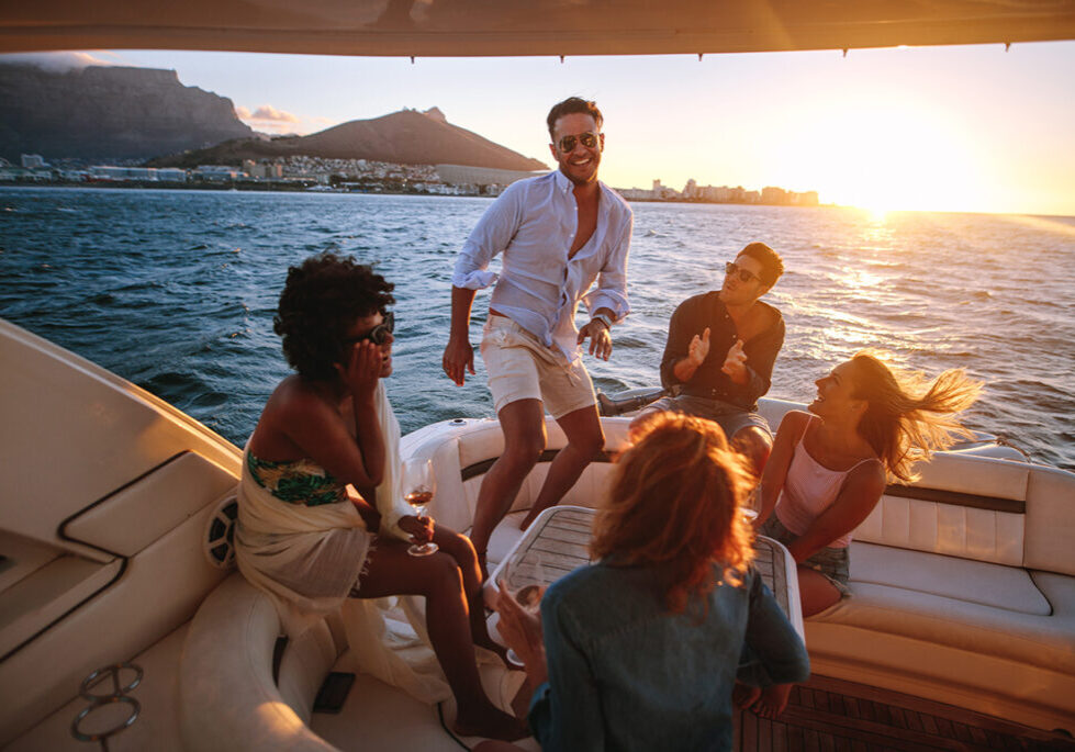 Five people sitting on a boat laughing