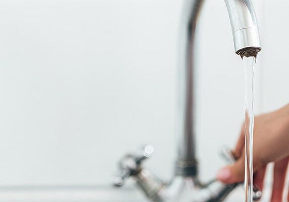 penney-assoc-camp-lejeune-water Hand turning on faucet tap