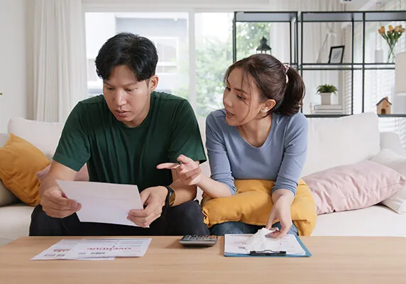 Couple looking at overdue bills