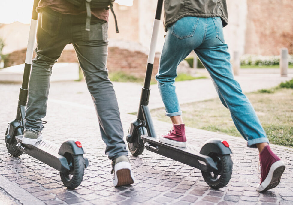 Image of two people riding e-scooters