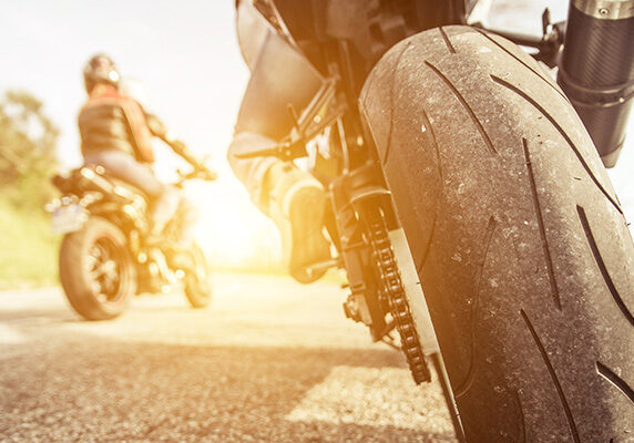 Low view of two motorcycles and riders on roadway