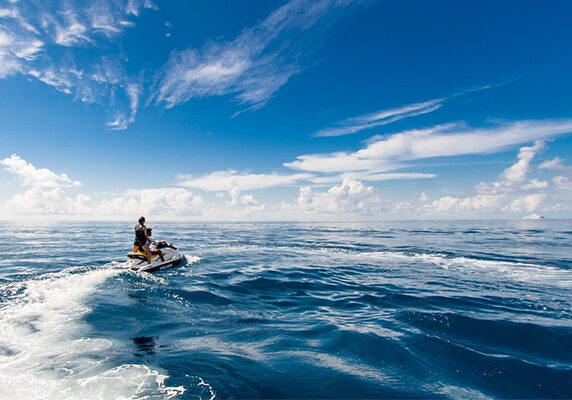 Couple riding on a jet ski in the ocean