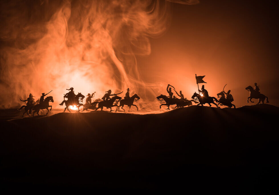Image showing two opposing armies charging towards each other, some on horseback