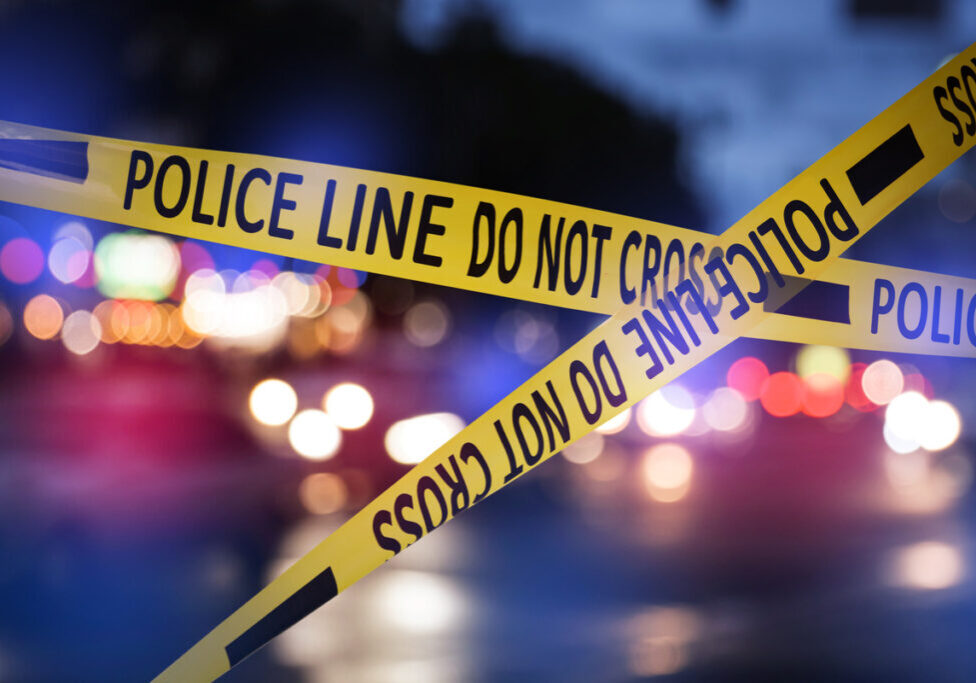 penney-assoc-radio-law-talk-may-10-25 Image of police tape in front of police lights