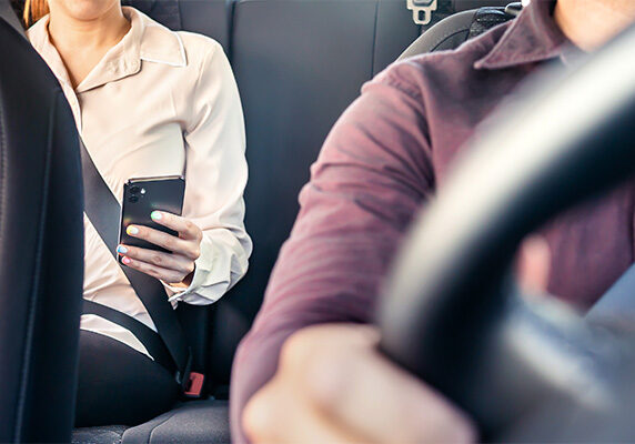 Woman sitting in ridesharing vehicle