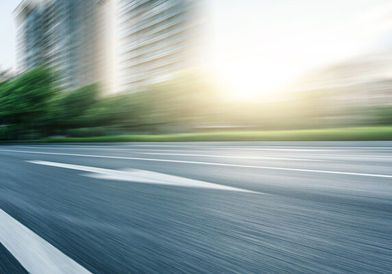 Image of a street with buildings in the background retouched with motion blur