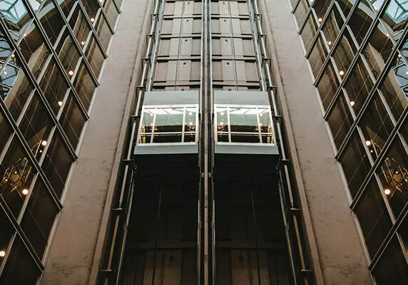 Image looking up at elevator moving up shaft