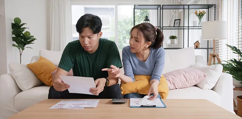 Couple looking at overdue bills